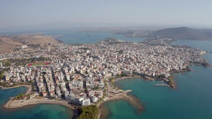 Wall Mural - 4k drone flight down footage (Ultra High Definition) of Chalcis town. Adorable morning seascape of Aegean sea, North Euboean Gulf. Incredible summer scene of Euboea island, Greece, Europe.