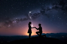 Silhouette Of A Romantic Young Couple With The Man Proposing At Night Against Beautiful Starry Sky