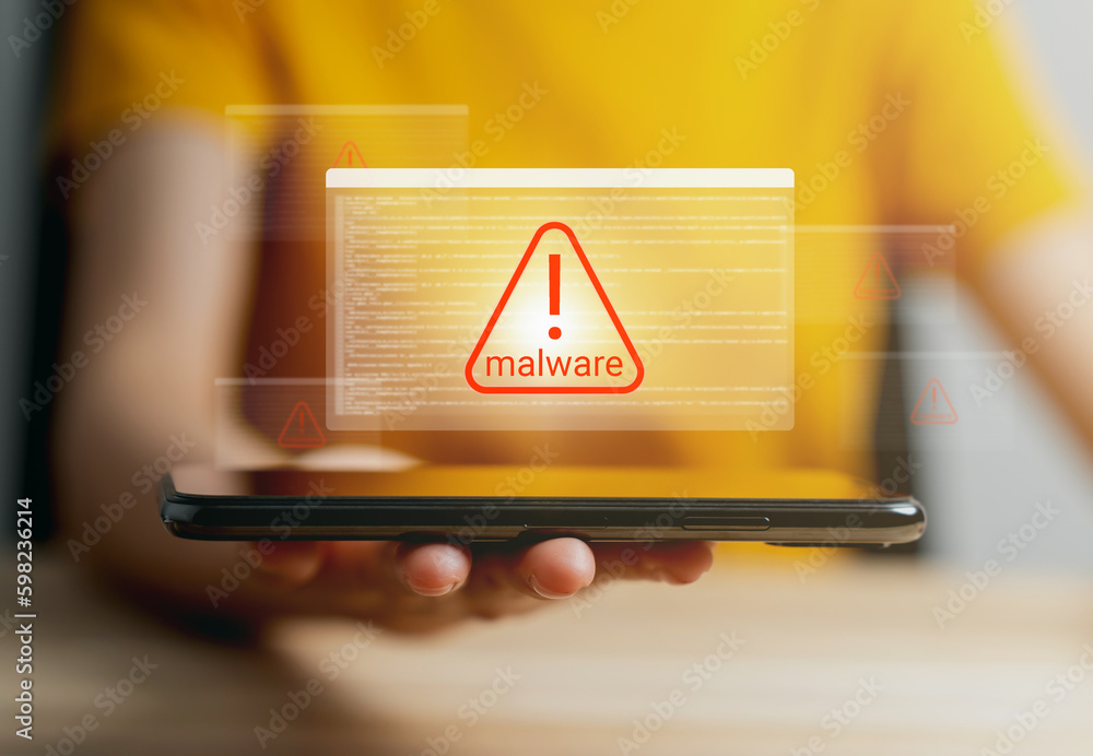 Hand holding smartphone with showing Malware alert on screen, Concept ...