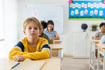 Group of student learn with teacher in classroom at elementary school. 