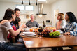 © Kawee - Multi-ethnic big family having dinner, enjoy evening party in house.