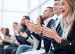© ASDF - group of employees applauds during a business meeting