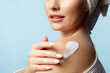© deniskomarov - Close up cream on the shoulder of a beautiful woman moisturizing skin after bathing procedures. The lady enjoys taking care of herself after her bath.