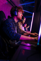 Wall Mural - Team of gamers playing online game on championship in cybersport club