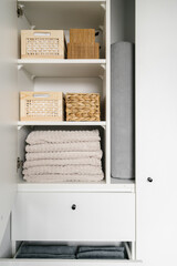 wood boxes with laundry in modern wardrobe, storage concept