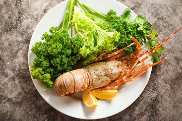 Wall Mural - spiny lobster food on plate, fresh lobster or rock lobster seafood with herb and spices lemon coriander parsley lettuce salad, lobster for cooking food