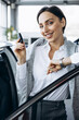 © Petro - Woman holding car keys by her new car