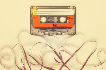 Wall Mural - vintage old audio compact cassette with loose tape underneath