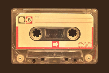 Wall Mural - vintage old audio compact cassette in front of a dark brown background