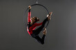 © Tetra Images - Teenage aerialist (14-15) practising on gymnastic hoop