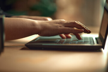 Close-up image of female hands typing on keyboard. Business woman working on laptop, making projects. Concept of business, career development, profession, occupation, technologies