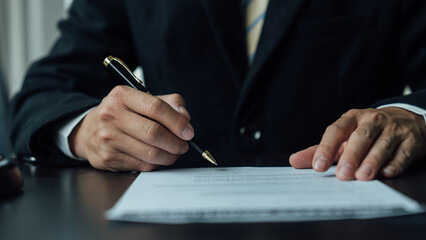 Legal consultant and real estate attorney lawyer read the building lease contract signing agreement for local business.