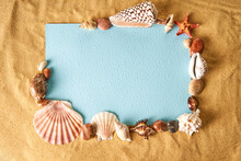 Invitation Or Greeting Card Mockup In Frame Of Seashells And Starfish On The Ocean Sandy Beach Background.