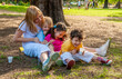 © Andriy Petrenko - Joyful family in the park on the grass