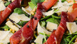 cold dish made with sliced bresaola flakes of grana cheese and green rocket leaves