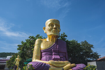 Wall Mural - Big Golden luang pu thuad Statue on koh lan island.Koh lan island is the Famous island near Pattaya city Thailand Nual Beach