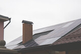Fototapeta  - Solar panels on houses and roof