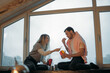 © Anna - A man and a woman are sitting on the windowsill and eating Chinese noodles. Food to order, food delivery.