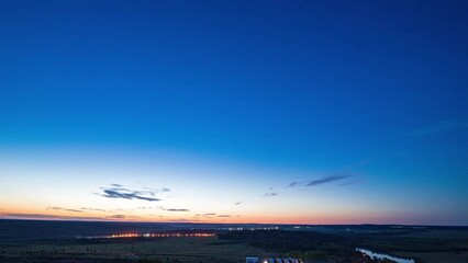 Wall Mural - Time-lapse sunrise over beautiful lake. Water surface in fast motion. Warm sky with rolling clouds. Trees silhouette woodland on horizon. Early morning shot in timelapse. Bright sun Generative AI