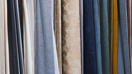 Poster - Mix colorful hanging vertical stripe textile, fabrics, cloths on the rack. Texture of multicolored fabrics close up.