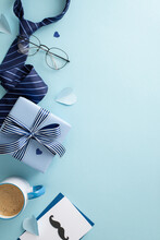 Classy Father's Day Concept. Top View Flat Lay Of Envelope With Card, Gift Box, Necktie, Accessories, Hearts, Spectacles, Coffee Cup On Blue Background With Space For Message Or Advert
