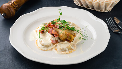 Canvas Print - Lunch ravioli with bacon pieces, greens and sauce in plate.