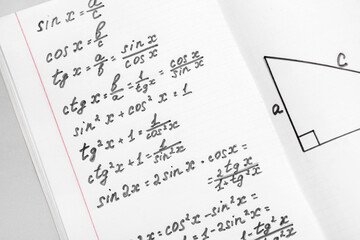 Copybook with maths formulas, closeup