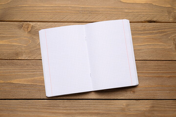 Blank copybook pages on wooden background
