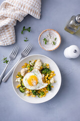 Wall Mural - Healthy breakfast bowl with cooked vegetables and fried egg