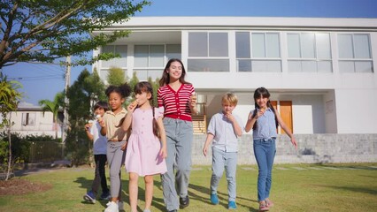 Wall Mural - Group of children eating an ice cream with teacher together in garden. 