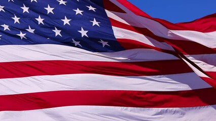 Wall Mural - close up of the us flag blowing in the breeze.