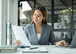 © Orathai - Asian businesswoman sit at their desks and calculate financial graphs showing results about their investments, plan a successful business growth process