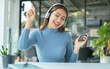 © Orathai - Happy Asian girl wearing headphones listening to music enjoy on smartphone digital. relaxation concepts