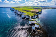 Aerial Panoramic View Of Limestone Cliffs And Stacks With Countryside At Old Harry Rocks In Dorset, UK.