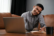 © bongkarn - Busy and professional mature Asian businessman working from home, talking on the phone
