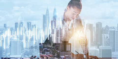 Canvas Print - Attractive young european businesswoman using laptop with glowing candlestick forex chart on blurry light city background. Trade, finance and concept. Double exposure.