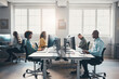 © Flamingo Images - Diverse businesspeople working on computers at desks in an office