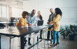 © Flamingo Images - Smiling businesspeople working together around an office table