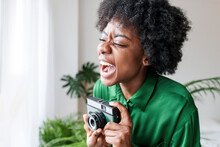 Cheerful Young Woman With Retro Style Camera