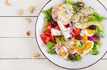 Wall Mural - Chicken meatloaf and fresh vegetable salad of tomato, avocado, eggs, lettuce and feta cheese. Ketogenic, keto diet. Top view, overhead