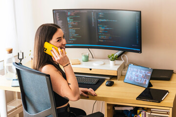 remote worker taking call surrounded by tech devices