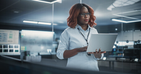 Aufkleber - Technological Software Engineering Department Manager Standing and Using a Laptop Computer. Black Female Looking in the Distance and Thinking while Working in the Office