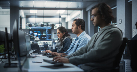 Team of Talented Young Indian Professionals Working in a Technological Research and Development Agency. Computer Screens with Software Code and Technical Neural Network Diagrams