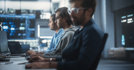 Young Passionate Specialist Working on Computer, Programming a Software for an Innovative Technological Internet Product Launch. Diverse Indian Team Working in a Startup Agency