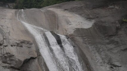 Wall Mural - Slow motion of flowing water waterfall in tropical forest