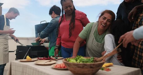 Wall Mural - Grandmother having tender moment with granddaughter - Multiracial friends having fun preparing food with female child during weekend day - Multi generational people doing barbecue at home's rooftop