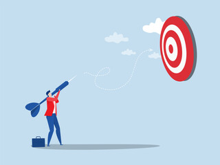achieve target concept ,businessman holding dart to target bullseye to win in business strategy goal