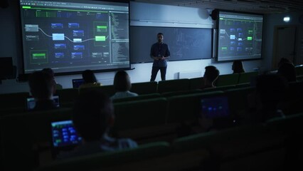 Aufkleber - Young Male Lecturer Giving a Web Development Masterclass to Diverse Multiethnic Group of Female and Male Students in Dark College Room. Projecting Slideshow with Initial Programming Project Plan