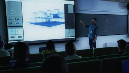 Leinwandbilder - Young University Professor Explaining an Interior Design Styles Lecture to a Group of Diverse Multiethnic Students in a Dark Auditorium. Teacher Showing a Housing Project on Two Big Screens