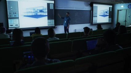 Fototapete - Young Male Lecturer Giving an Architectural Engineering Lecture to Diverse Multiethnic Group of Female and Male Students in Dark College Room. Projecting Slideshow with a Private House Blueprint